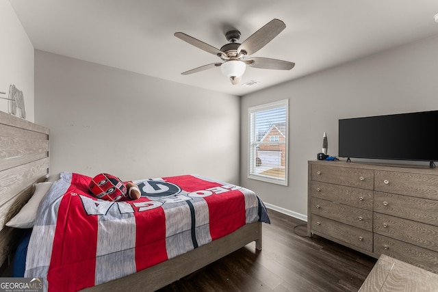 bedroom with ceiling fan and dark hardwood / wood-style flooring