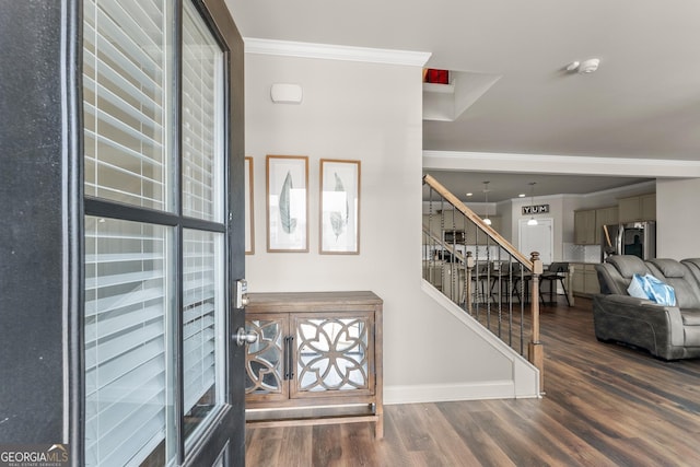 entryway featuring wood-type flooring and ornamental molding