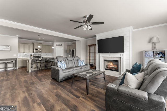 living room featuring ceiling fan, ornamental molding, and dark hardwood / wood-style flooring