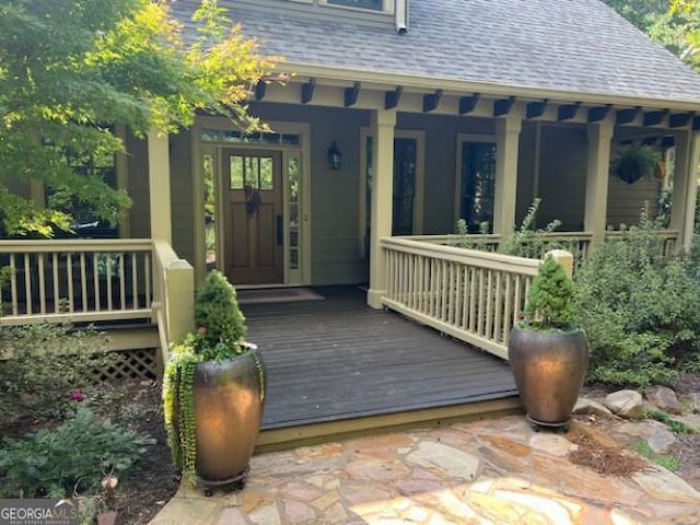 view of exterior entry featuring a porch