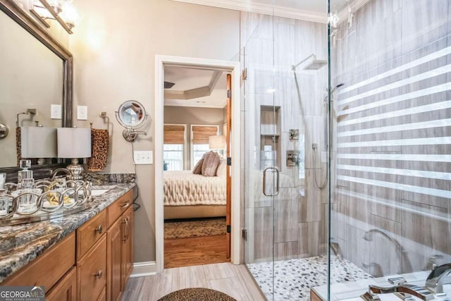 bathroom featuring ornamental molding, an enclosed shower, and vanity