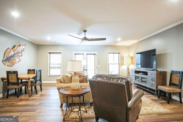 living room featuring ceiling fan, hardwood / wood-style flooring, ornamental molding, and a healthy amount of sunlight