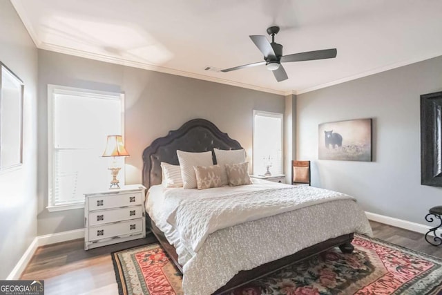 bedroom featuring ceiling fan, ornamental molding, and hardwood / wood-style floors