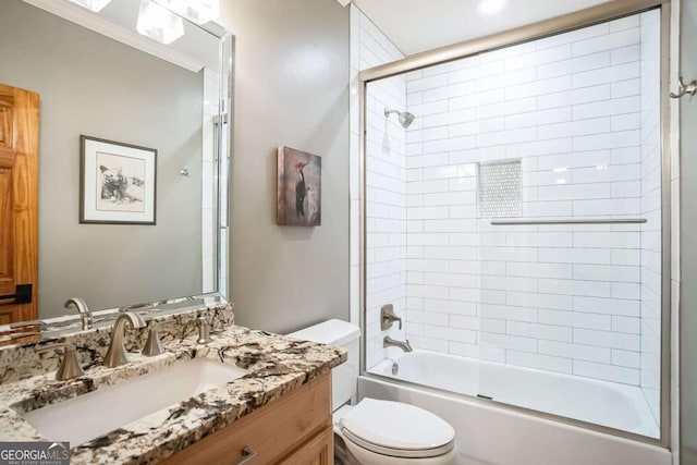 full bathroom featuring vanity, crown molding, bath / shower combo with glass door, and toilet