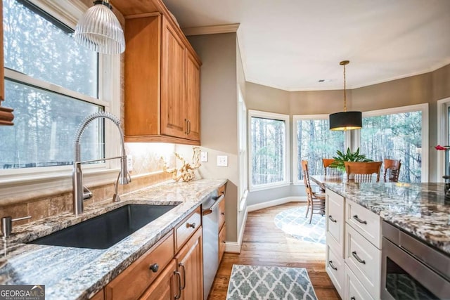 kitchen featuring light stone countertops, sink, white cabinets, and appliances with stainless steel finishes