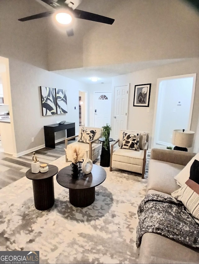 living room featuring hardwood / wood-style floors and ceiling fan