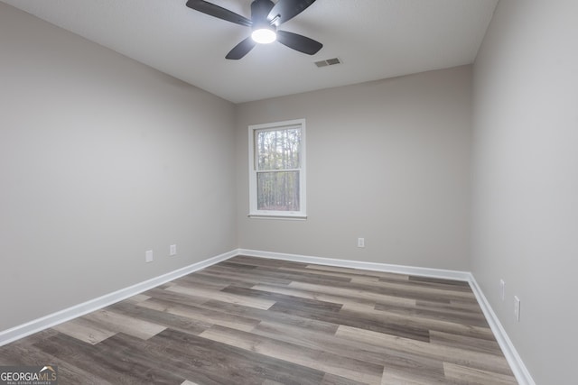 spare room with hardwood / wood-style flooring and ceiling fan