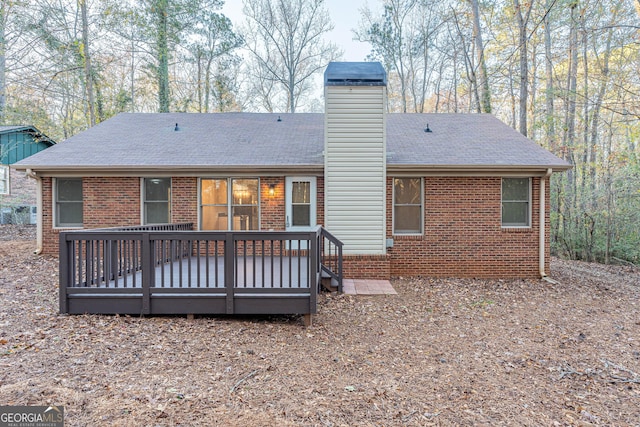 rear view of property featuring a deck