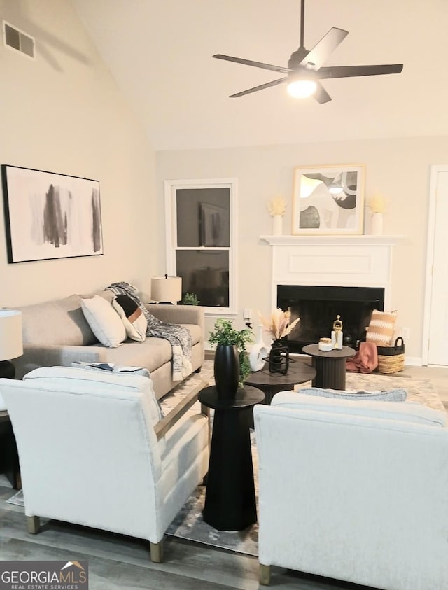 living room featuring vaulted ceiling, dark hardwood / wood-style flooring, and ceiling fan