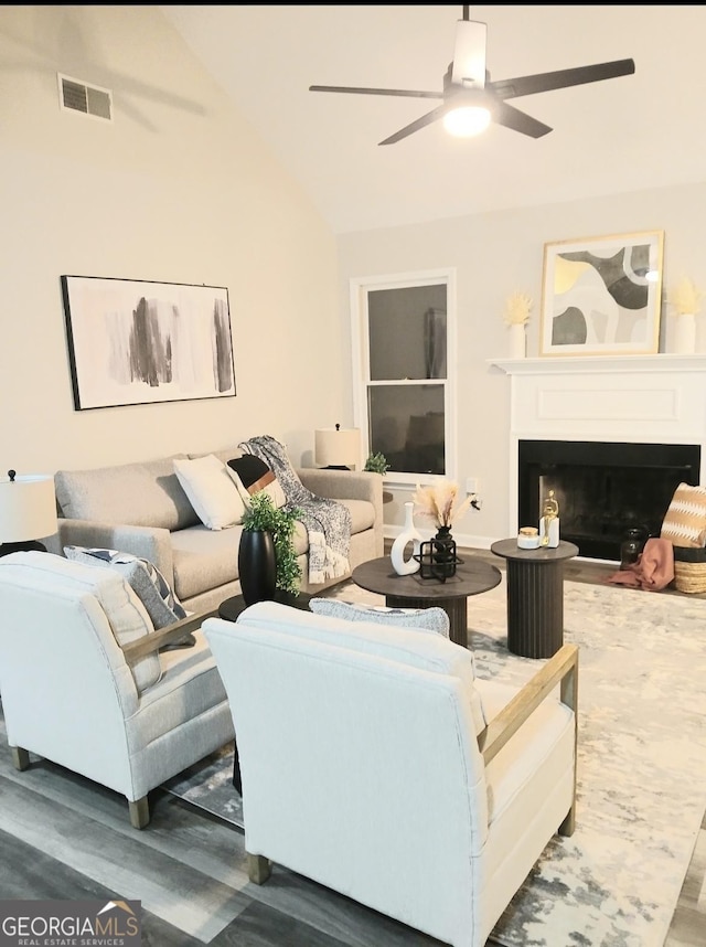 living room with vaulted ceiling, dark wood-type flooring, and ceiling fan