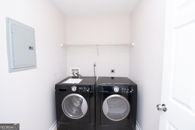 washroom with electric panel and washing machine and dryer