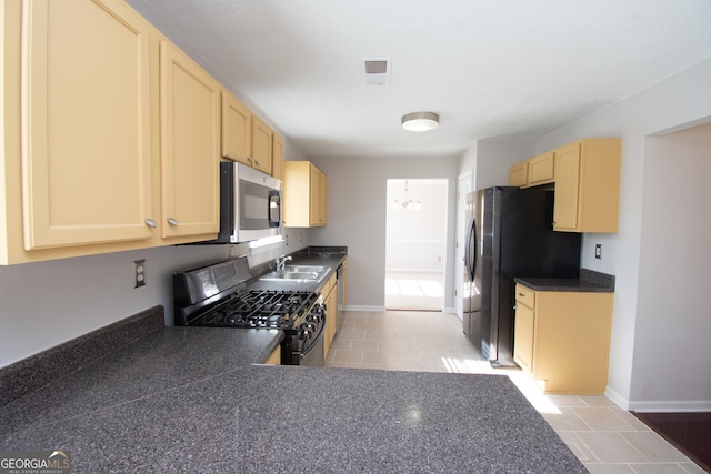 kitchen featuring a notable chandelier, stainless steel appliances, sink, and light brown cabinets