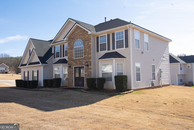 front of property featuring a front lawn and central air condition unit