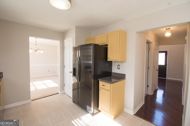 kitchen with an inviting chandelier and stainless steel fridge