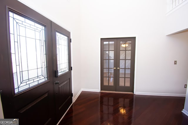 entrance foyer with dark hardwood / wood-style floors and french doors