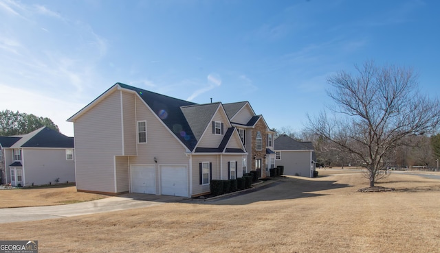 view of side of home with a garage and a yard