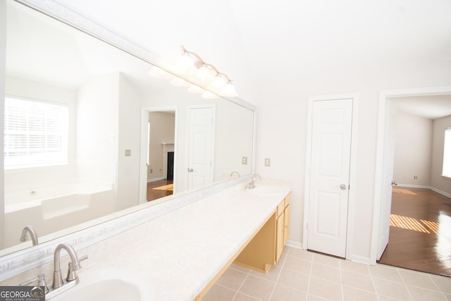 bathroom with vanity, a washtub, and tile patterned floors