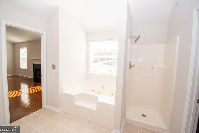 bathroom featuring tile patterned floors and separate shower and tub