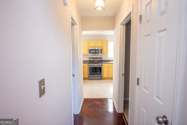 hallway with hardwood / wood-style floors