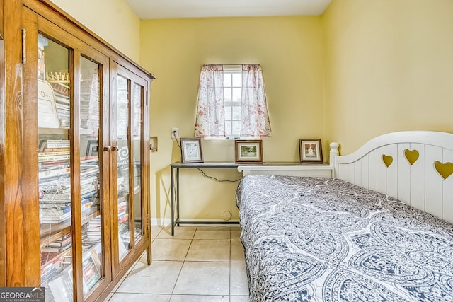 bedroom featuring light tile patterned floors, baseboards, and french doors