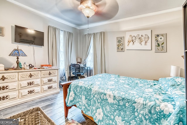 bedroom featuring dark wood-type flooring, ceiling fan, and ornamental molding