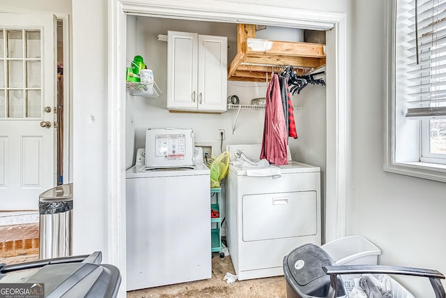 washroom with separate washer and dryer and cabinets