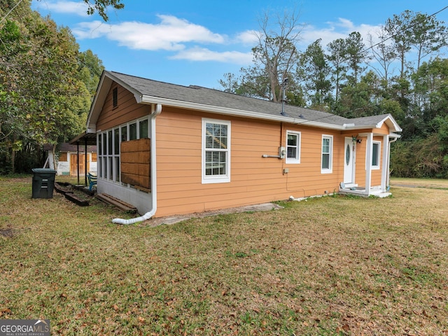 view of side of home featuring a yard