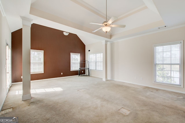 unfurnished room featuring visible vents, light carpet, a tray ceiling, decorative columns, and ceiling fan