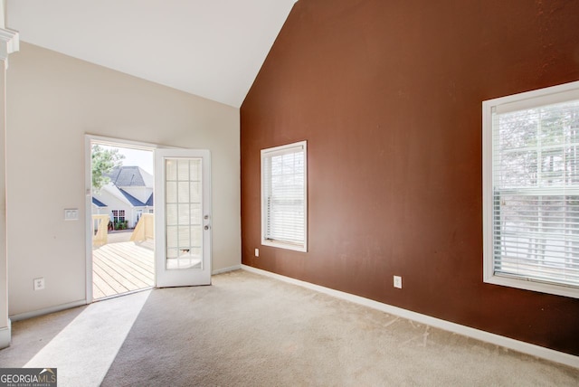 interior space featuring baseboards and high vaulted ceiling