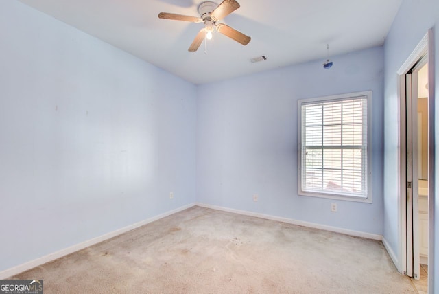 unfurnished room with ceiling fan, baseboards, visible vents, and light carpet