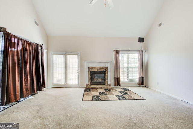 unfurnished living room with carpet, visible vents, and high vaulted ceiling