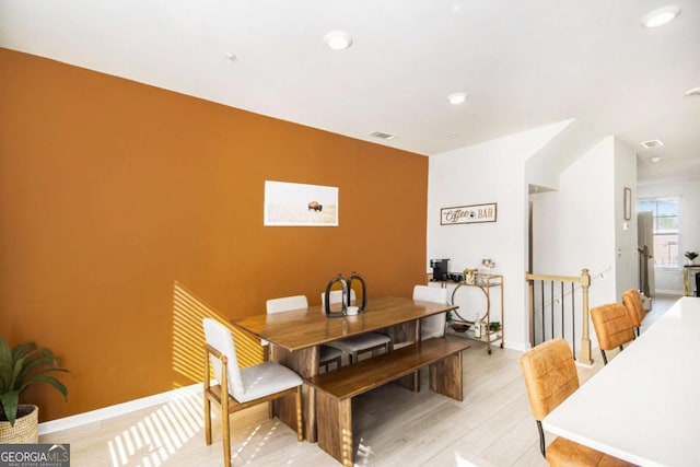 dining space with light hardwood / wood-style floors