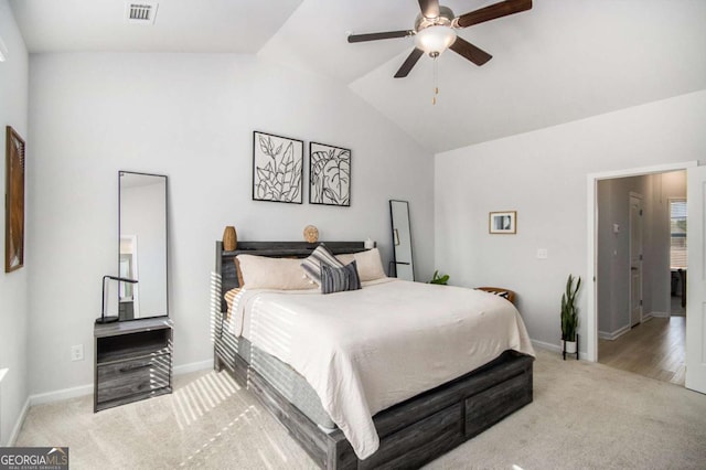 bedroom with light carpet, vaulted ceiling, and ceiling fan