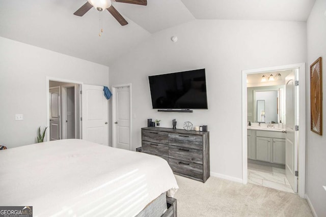 bedroom featuring ceiling fan, connected bathroom, vaulted ceiling, and light carpet