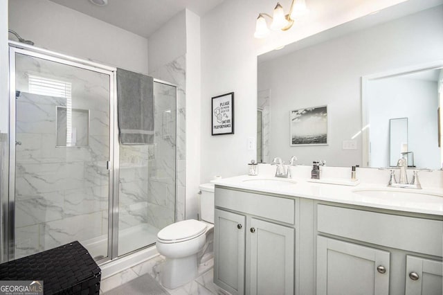 bathroom with a shower with door, vanity, and toilet