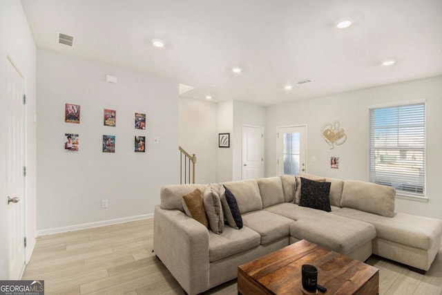 living room featuring plenty of natural light and light hardwood / wood-style flooring