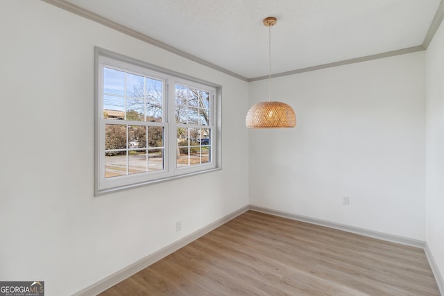 unfurnished dining area featuring crown molding and hardwood / wood-style flooring