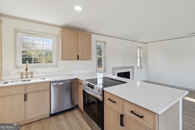 kitchen featuring stainless steel appliances, sink, light brown cabinets, and kitchen peninsula