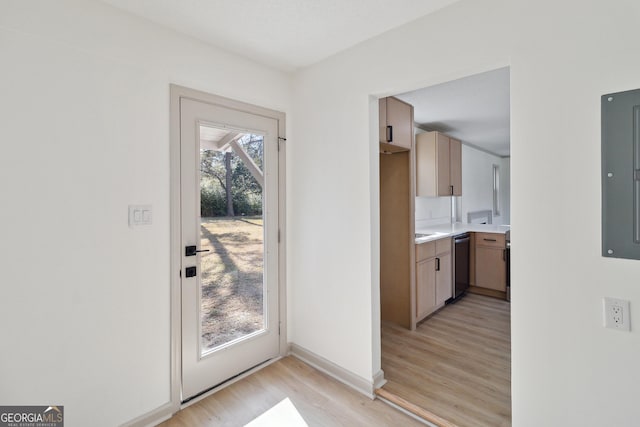 doorway to outside with light hardwood / wood-style flooring and electric panel