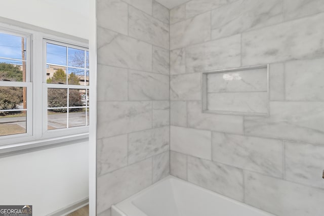 bathroom featuring a tub to relax in