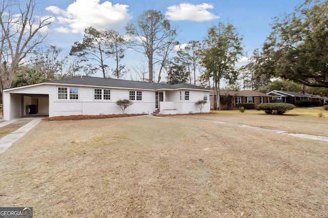 single story home featuring a carport and a front yard