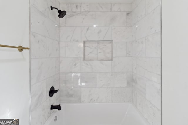 room details featuring tiled shower / bath