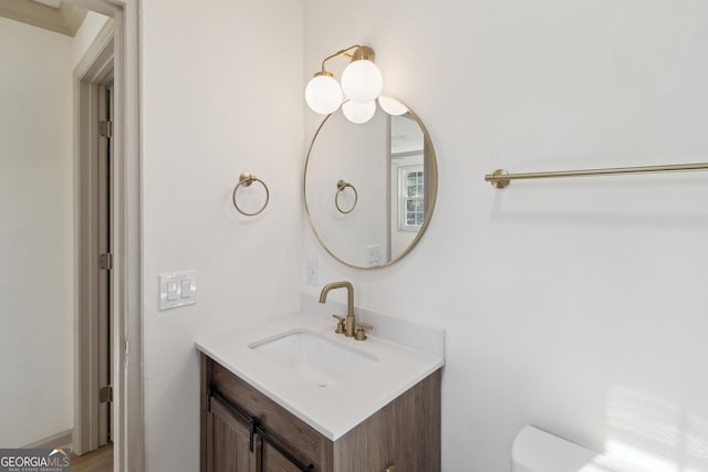 bathroom featuring vanity and toilet