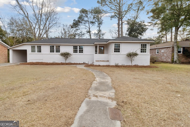 ranch-style home featuring a carport and a front lawn