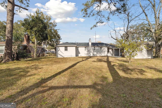 back of house with a yard