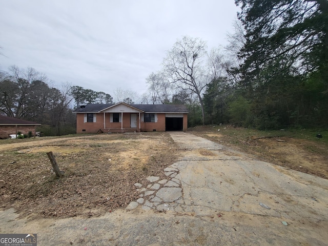 ranch-style house featuring a garage