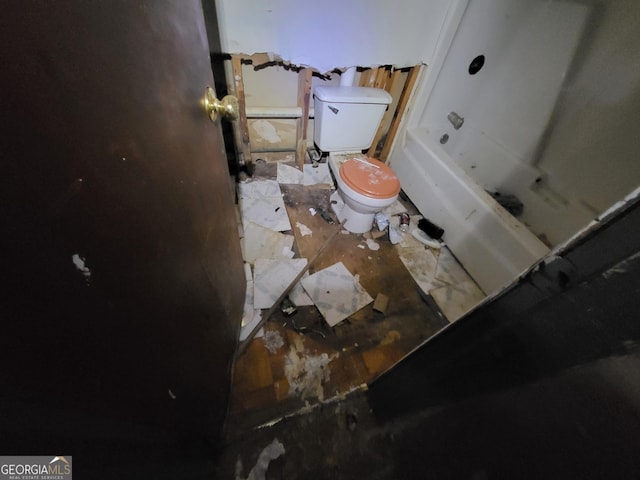 bathroom with toilet and a bathing tub