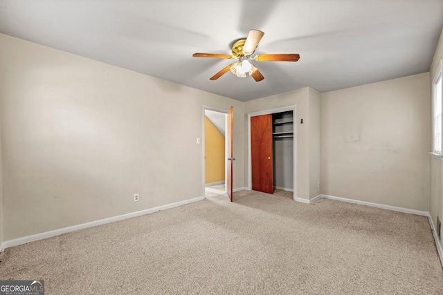 unfurnished bedroom with light colored carpet, ceiling fan, and a closet