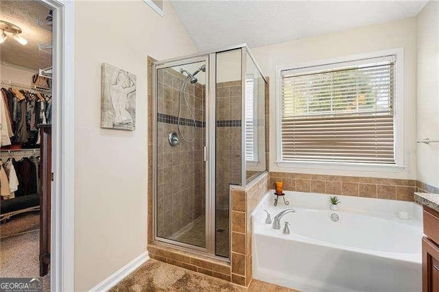 bathroom with vanity, a shower with door, and a textured ceiling