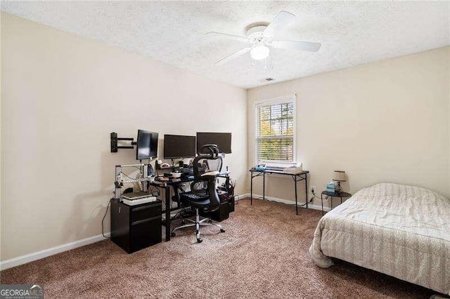 bedroom featuring ceiling fan, carpet flooring, and a textured ceiling